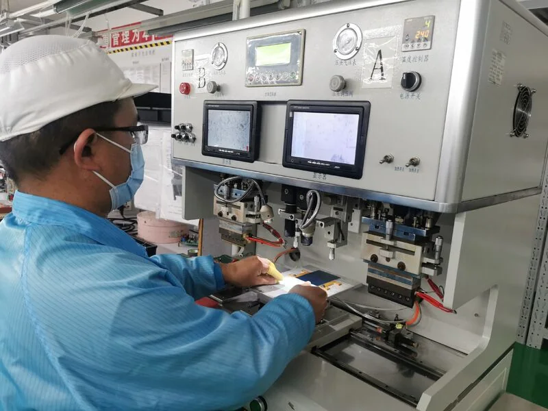 Operator at a COG bonding machine at Junxian